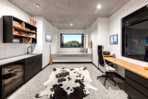 room with desktop, window and animal print rug