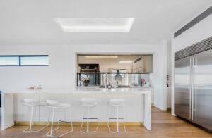 Finished with flawless craftsmanship in the finest materials, the interior features a neutral palette, wide oak floor boards and clean simple lines, creating a feeling of understated coastal luxury that allows the views to take centre stage. The designer kitchen forms the centre of the upper floor living space which flows from the ocean-side terrace through to the rear entertaining space and heated mineral pool, whilst maintaining visual continuity at all times with the stunning views. With only a staircase in the original structure, 30 metres of rock was hand cut to accommodate 4