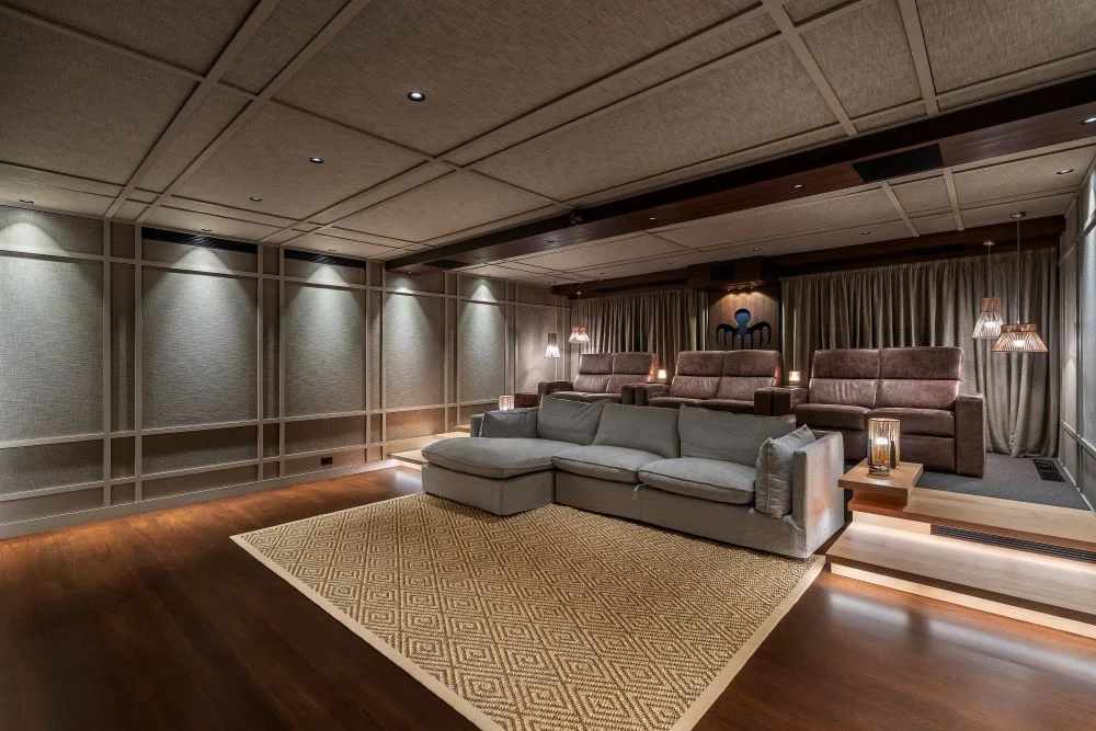 A theatre room with a couch and chairs