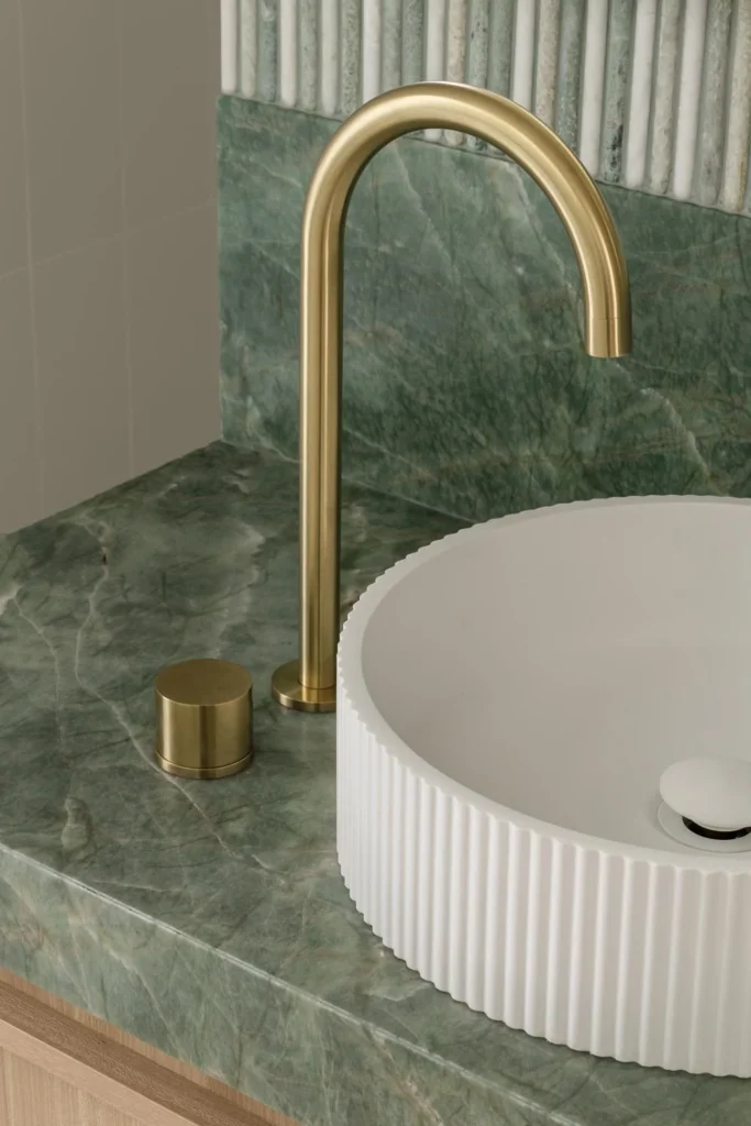 Happy-Haus-Modern-Interior-Design-Brushed-Brass-Tapware-White-Fluted-Basin-Brazillian-Emerald-Quartzile-Bench-Top.jpg