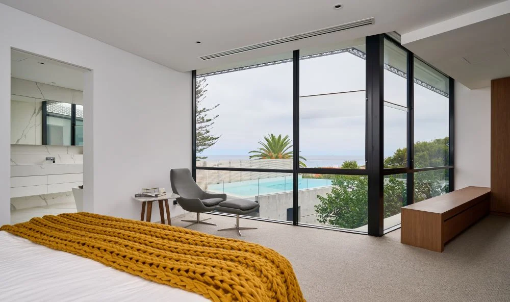 sculptural concrete home with landscaped gardens