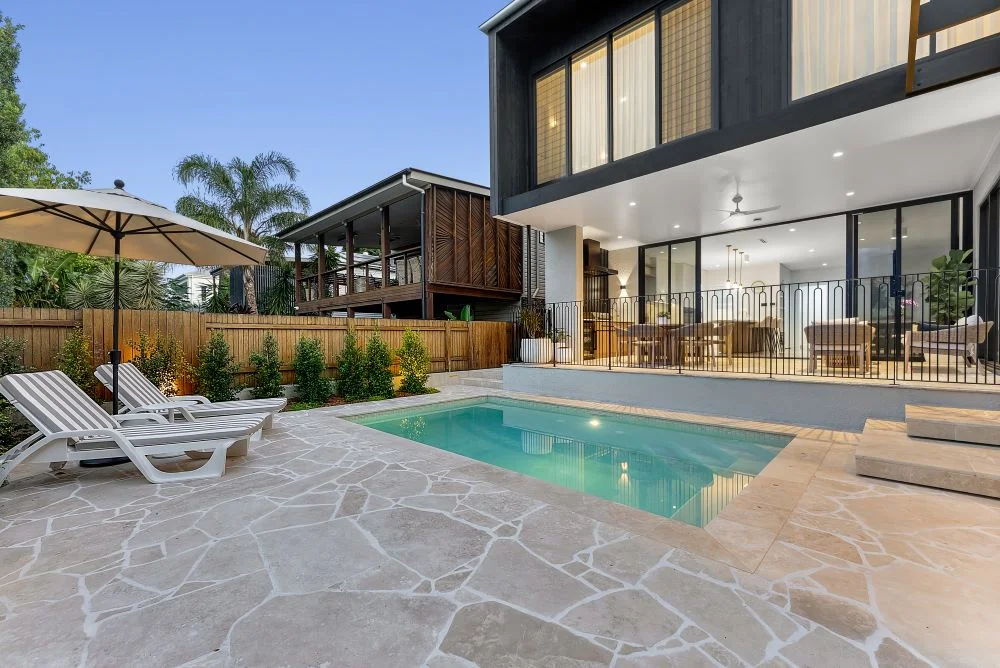 Covered outdoor entertaining area overlooking swimming pool