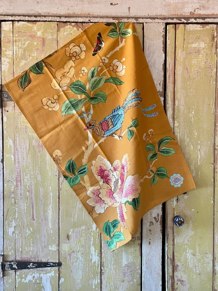 Gold Chinoiserie beach towel with oversized floral and bird pattern