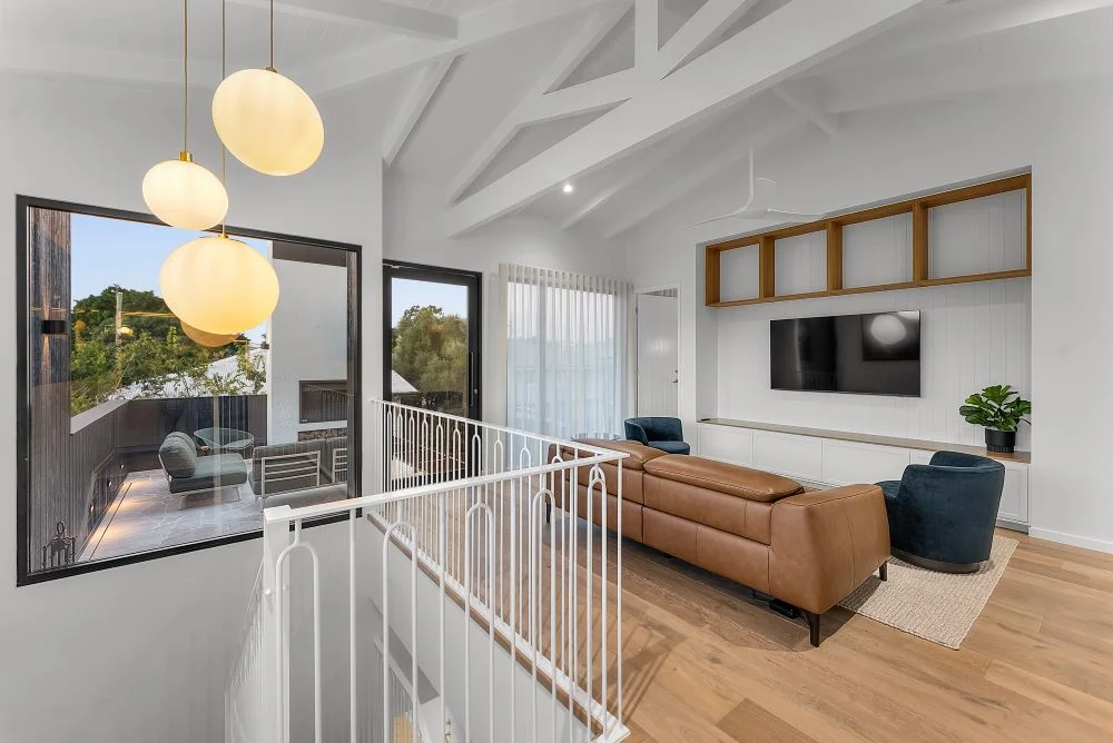 New Farm Queenslander upper-level living area with raked ceiling