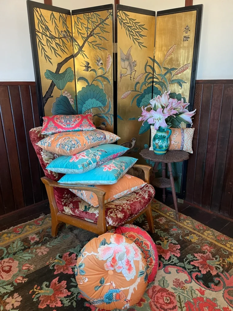 Gold Chinoiserie round velvet cushion with floral and bird pattern