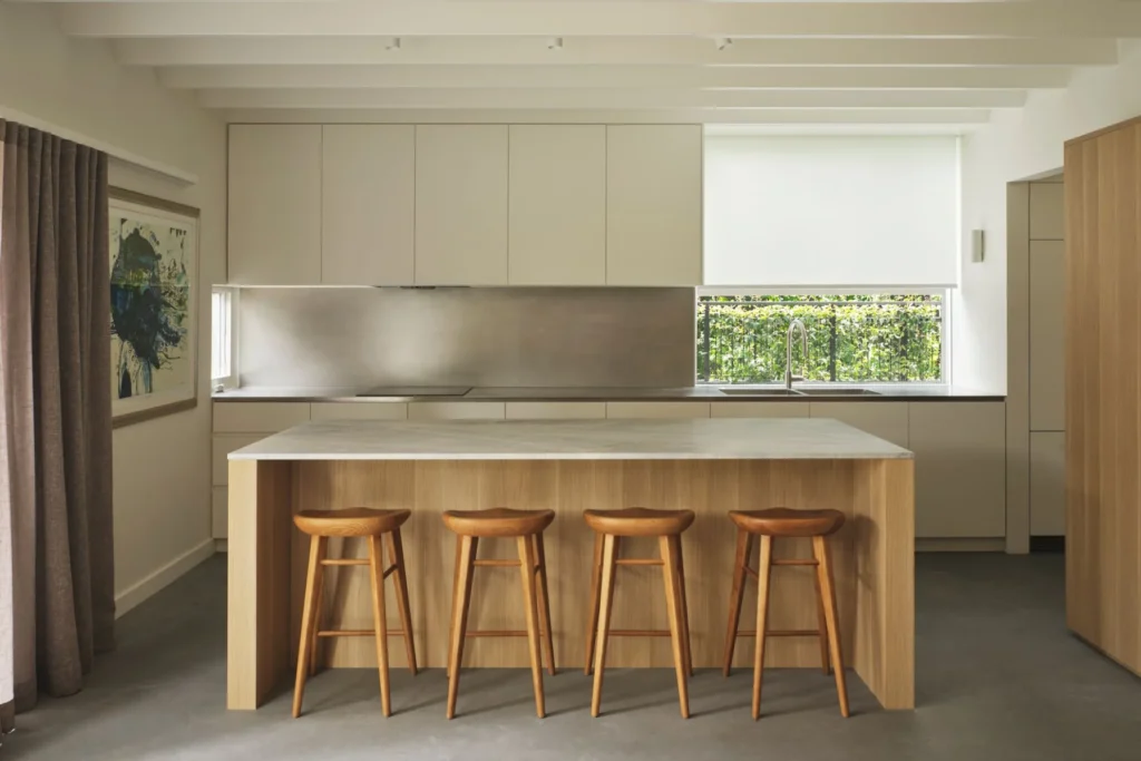 Carrara marble kitchen island with deep-grain oak cabinetry