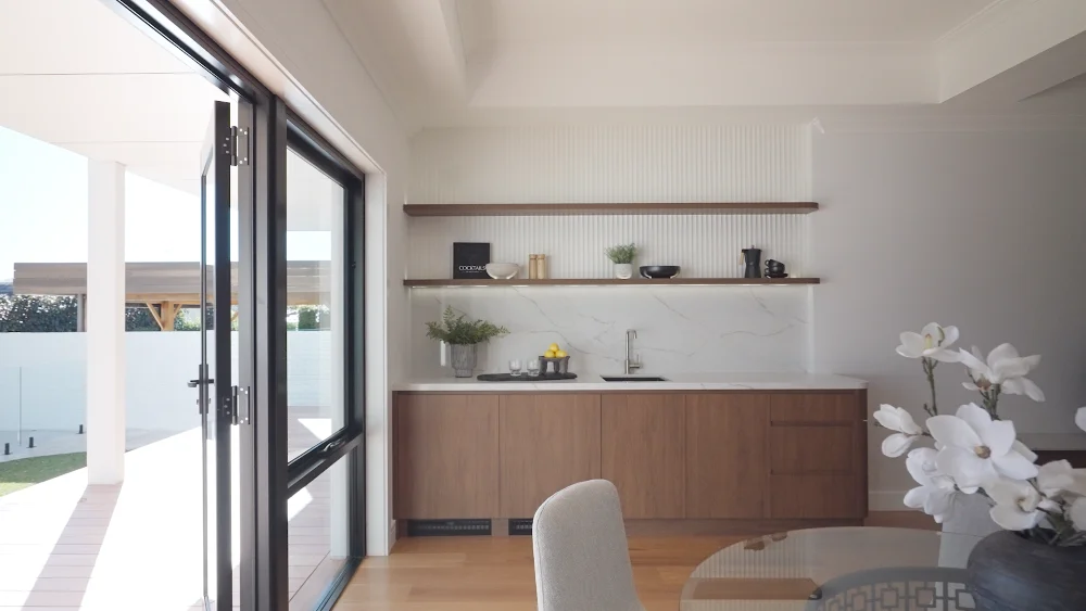 Concealed walk-in pantry integrated into vertical Steccawood cabinetry